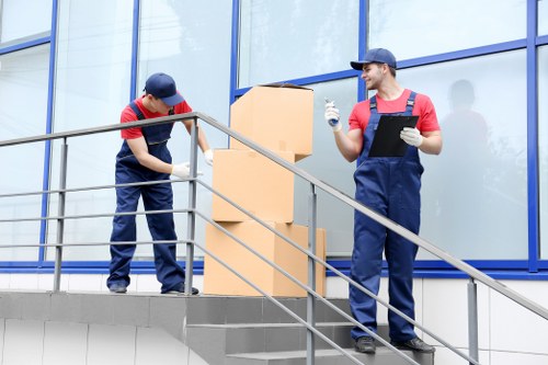 Professional removals vehicle loading household items in Harefield