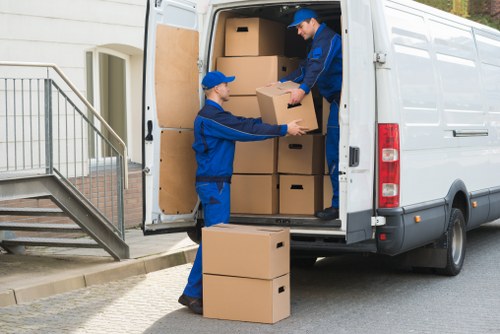 Local movers preparing furniture for transport in Harefield