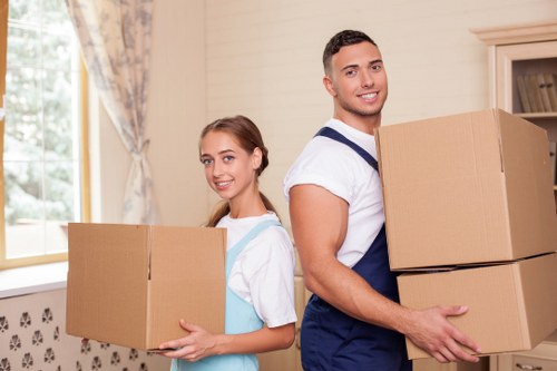 Staff member using safe lifting techniques during a move